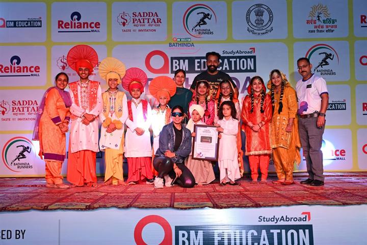 Bhangra artists in traditional Punjabi dress perform on the Bathinda Half Marathon 8.0 stage
